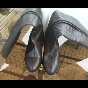 Dark brown tall wide calf riding boots.